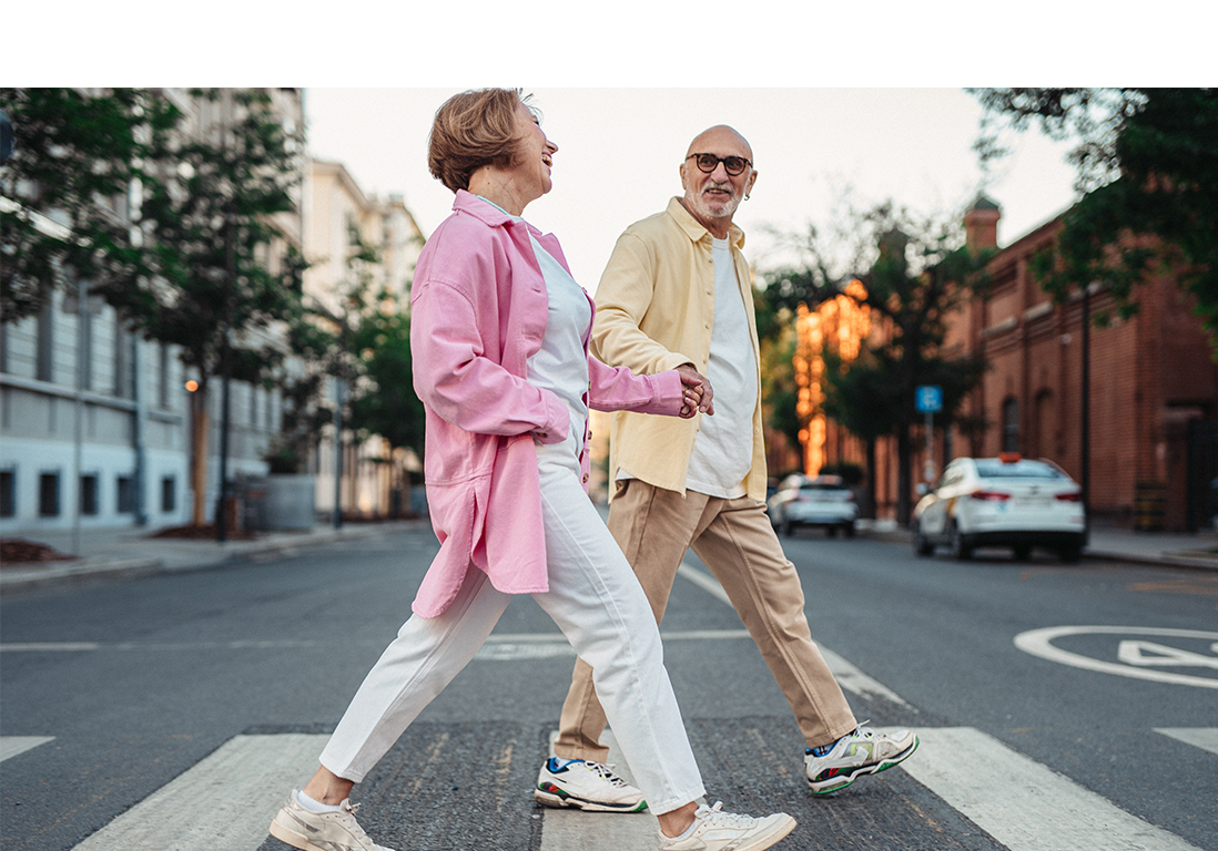 People walking over a zebra crossing laughing