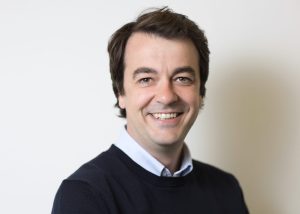 An image of Andrew Dines smiling at the camera.